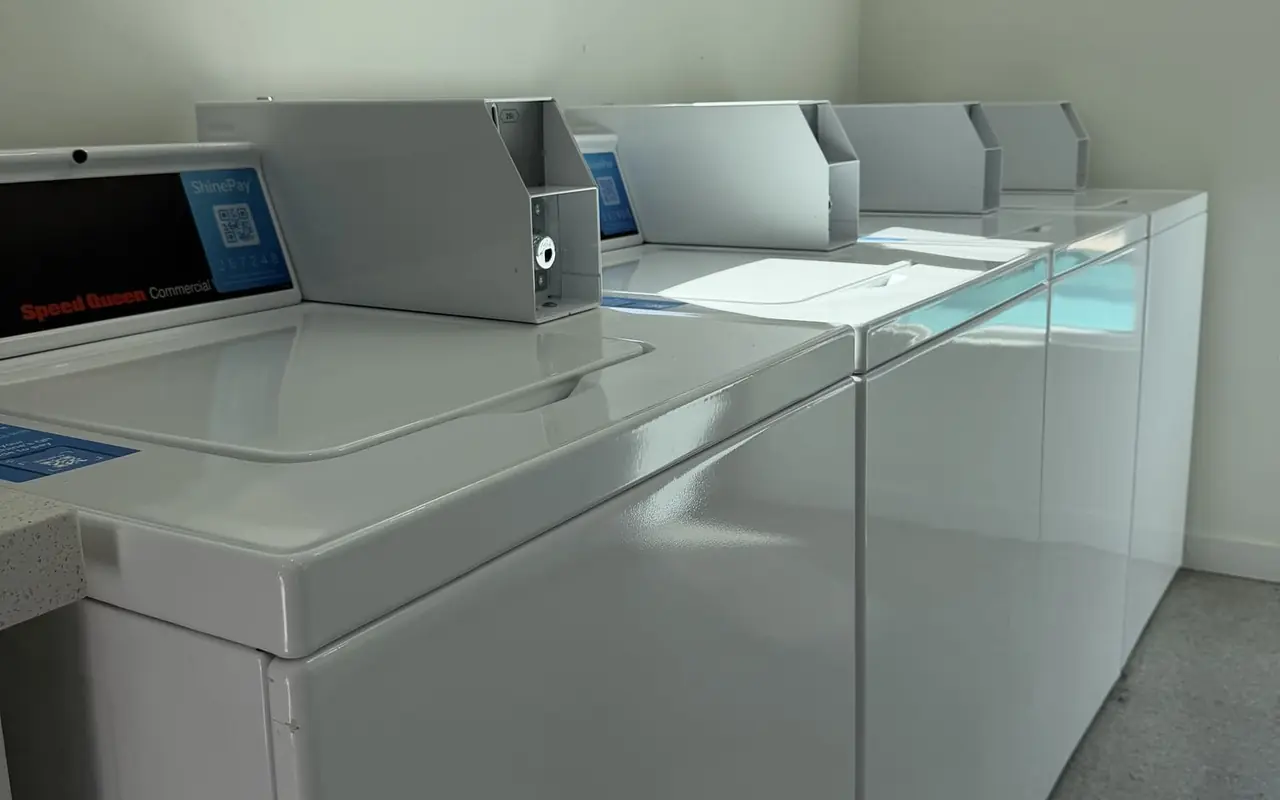 Apartment laundry room with commercial Speed Queen washers and dryers