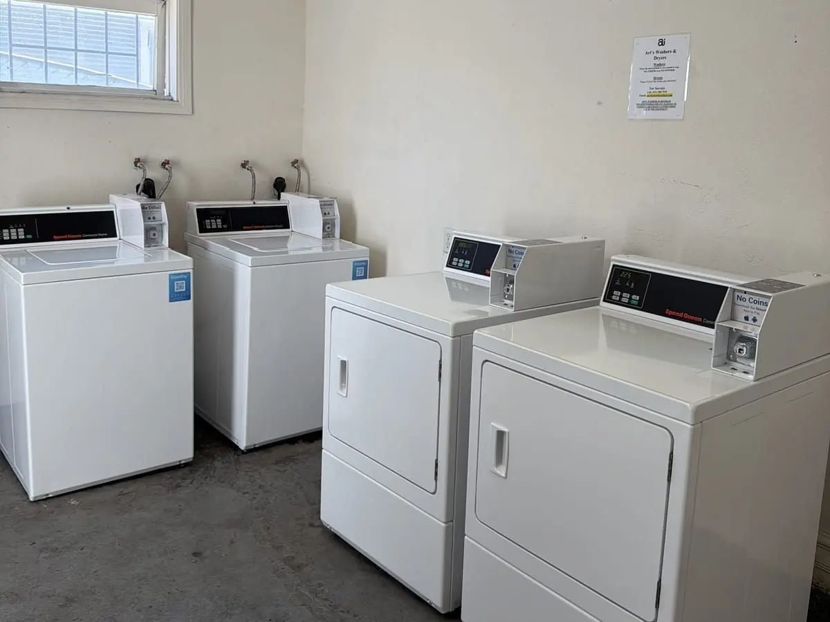 The same laundry room after Art's installed clean matched Speed Queen washers and dryers with ShinePay