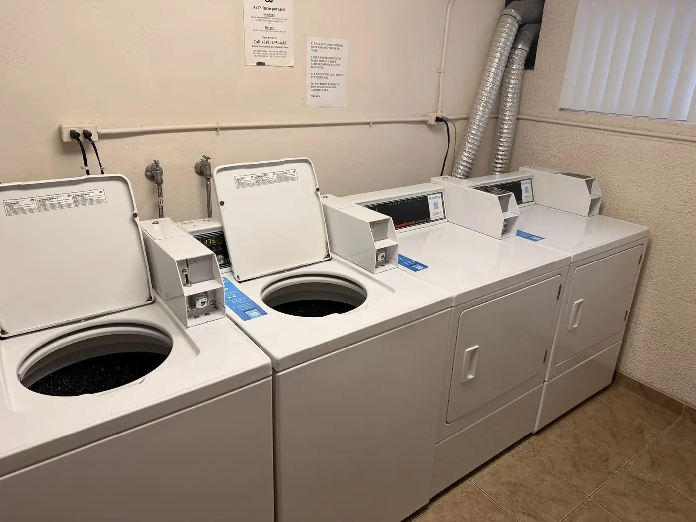 Row of commercial front-load washing machines